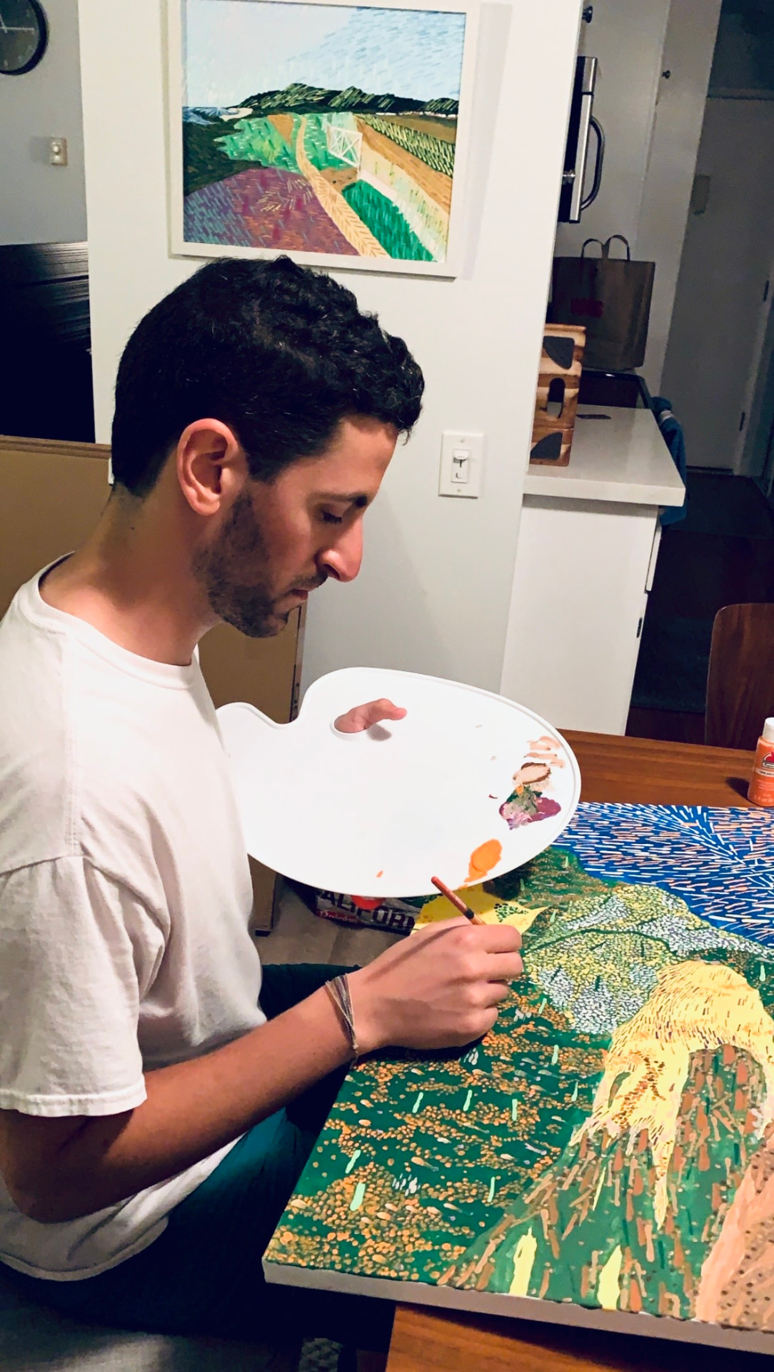 Yon Douek painting in his studio